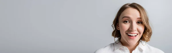 Excited overweight woman in white shirt looking at camera isolated on grey, banner — Stock Photo