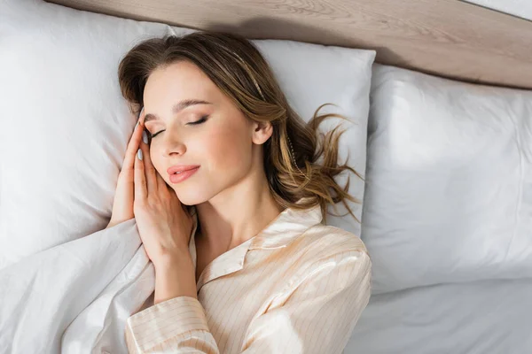 Mujer en pijama durmiendo en la cama - foto de stock