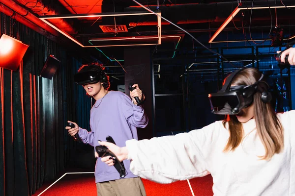 Multiethnic teenagers in headsets gaming in vr play room — Stock Photo