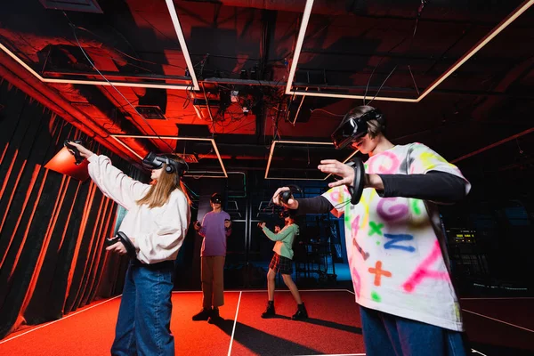 Interracial teenagers gaming in vr headsets in play zone — Stock Photo