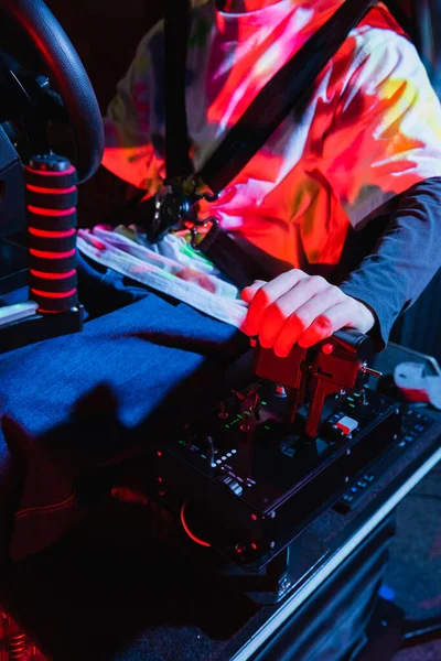 Cropped view of teenage guy operating gear box while gaming on car simulator — Stock Photo