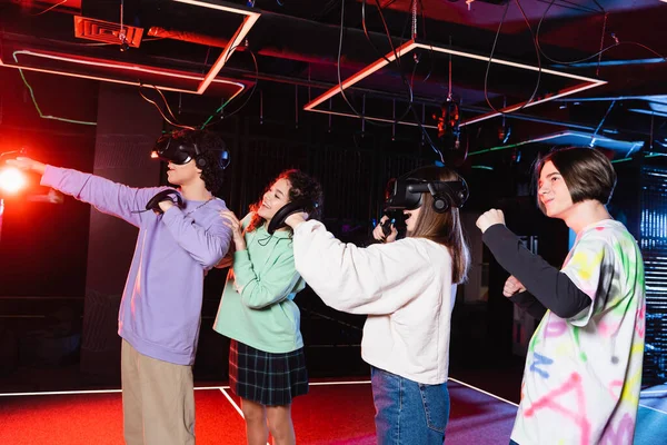 Excited multiethnic friends having fun while gaming in vr play zone — Stock Photo