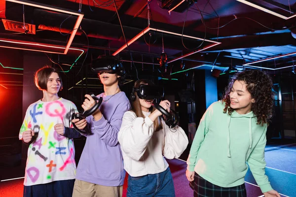 Cheerful interracial friends spending time in vr play room — Stock Photo