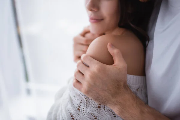 Cropped view of man touching shoulder of girlfriend in sweater — Stock Photo