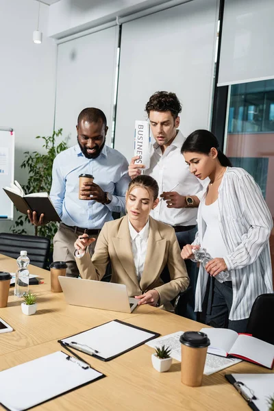 Multiethnische Geschäftsleute schauen bei Besprechung im Konferenzraum auf Laptop — Stockfoto