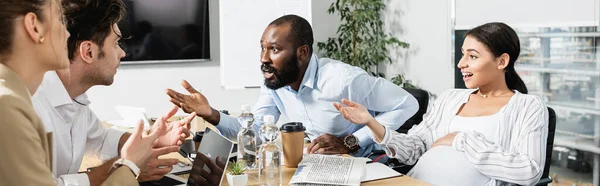 Multicultural business partners gesturing during discussion in conference room, banner — Stock Photo