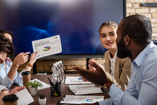 Interracial business partners gesturing during discussion in conference room — Stock Photo