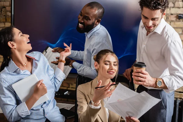 Excited multiethnic business people talking during meeting in conference room — Stock Photo