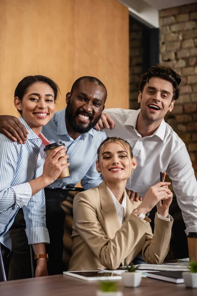 Successful multiethnic business partners looking at camera in conference room — Stock Photo