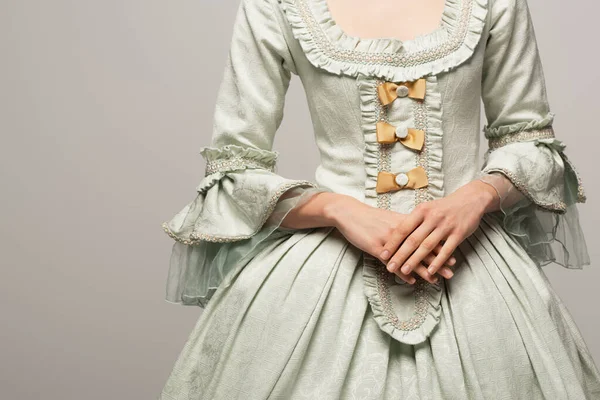 Partial view of woman in elegant vintage dress isolated on grey — Stock Photo