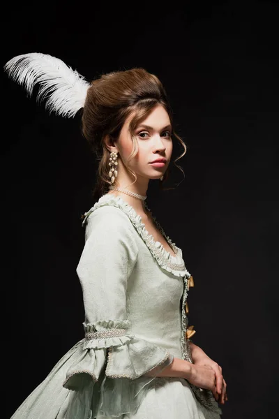 Sensual woman in elegant vintage dress looking at camera isolated on black — Stock Photo