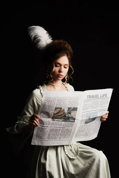 Affascinante donna in abito retrò lettura vita di viaggio giornale isolato su nero — Foto stock