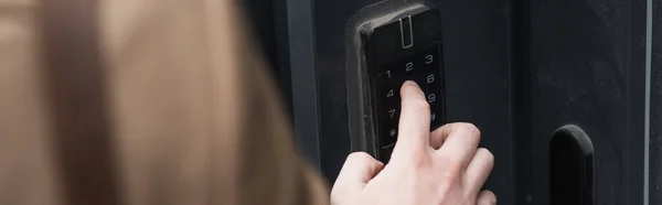 Cropped view of man pressing button on intercom keypad, banner — Stock Photo