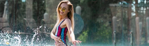 Cheerful woman splashing water of swimming pool, banner — Stock Photo