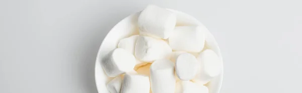 Top view of soft and puffy marshmallows in bowl on white, banner — Stock Photo