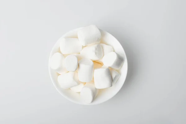 Top view of soft and puffy marshmallows in bowl on white — Stock Photo