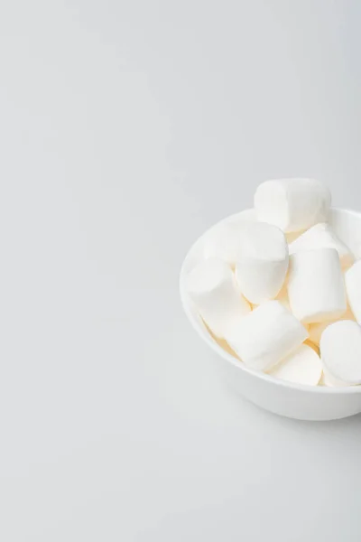 High angle view of soft and puffy marshmallows in bowl on white — Stock Photo