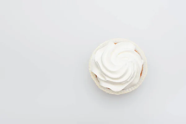 Top view of sweet cupcake with icing on top isolated on white — Stock Photo