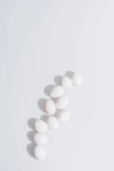 Vista superior de huevos crudos y orgánicos con cáscara sobre fondo blanco - foto de stock