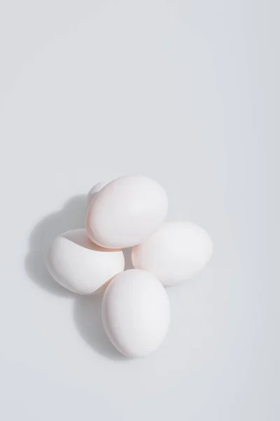 High angle view of fresh eggs in shell on white background — Stock Photo