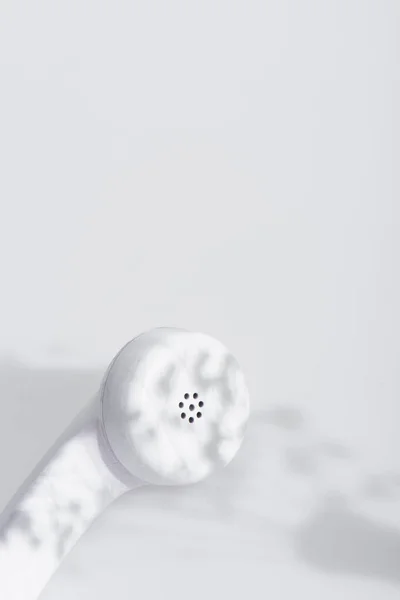 Shadows on retro telephone handset on white — Stock Photo