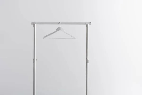 White hanger on garment rack isolated on grey — Stock Photo