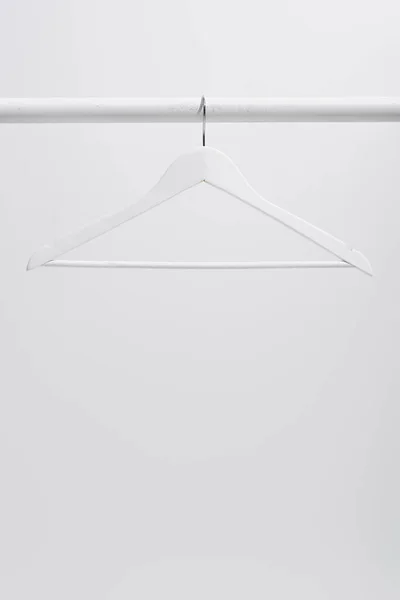 White hanger on clothing rack isolated on gray — Stock Photo