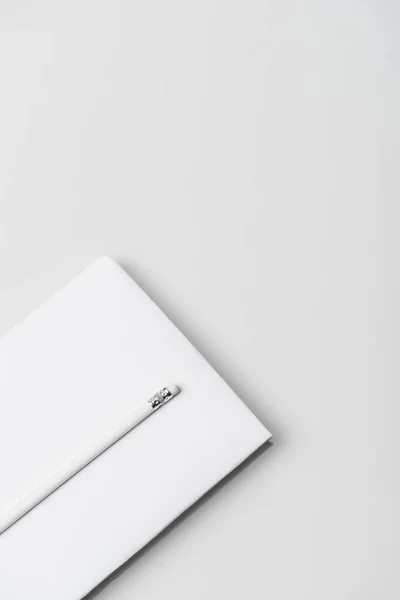 Top view of notebook in hardcover and pencil isolated on white — Stock Photo