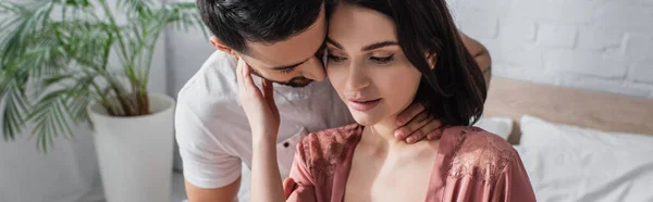 Joven tocando cuello de novia en peignoir en dormitorio, bandera - foto de stock