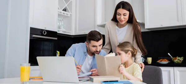 Woman smiling near husband and daughter doing homework together, banner — Stock Photo