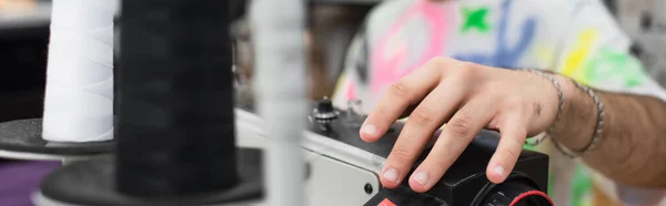 Cropped view of tailor regulating sewing machine during work in atelie, banner — Stock Photo