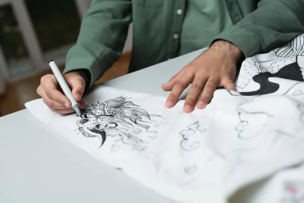 Partial view of fashion designer drawing on kimono with felt pen on blurred foreground — Stock Photo