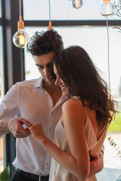 Man holding hands with cheerful girlfriend — Stock Photo