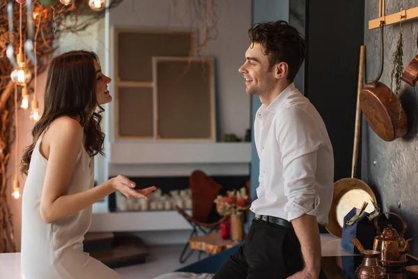 Side view of cheerful couple looking at each other in restaurant — Stock Photo