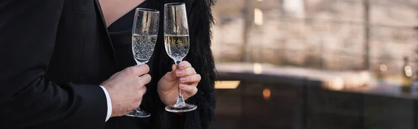 Partial view of man and woman clinking glasses of champagne, banner — Stock Photo