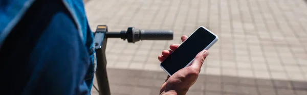 Cropped view of man holding smartphone with blank screen outside, banner — Stock Photo