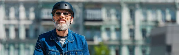 Positive man in sunglasses and helmet in urban city, banner — Stock Photo