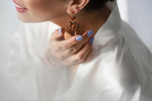 Cropped view of smiling indian bride wearing earring isolated on white — Stock Photo