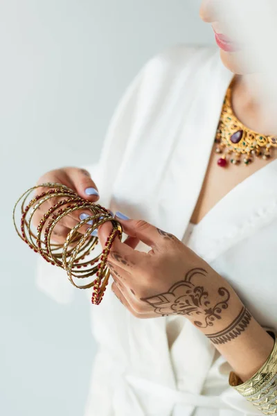 Vista cortada da noiva indiana com mehndi segurando pulseiras — Fotografia de Stock