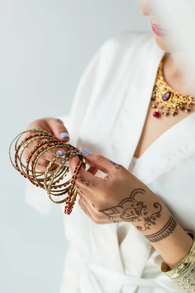 Cropped view of indian bride with mehndi holding bracelets — Stock Photo