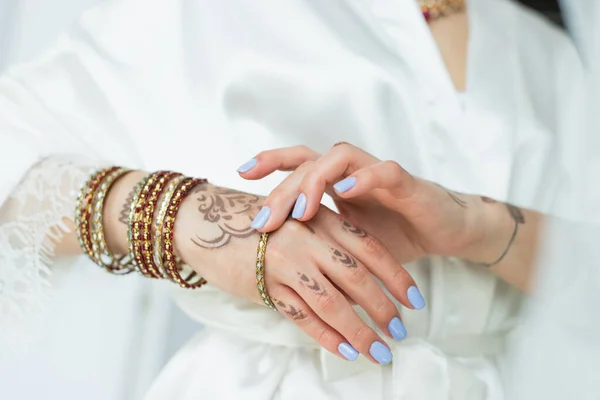 Vue recadrée de la mariée indienne avec mehndi sur les mains portant des bracelets — Photo de stock