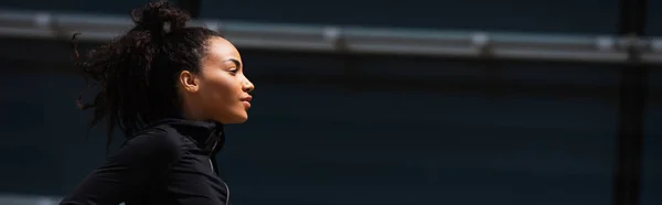 Side view of african american sportswoman looking away outdoors, banner — Stock Photo