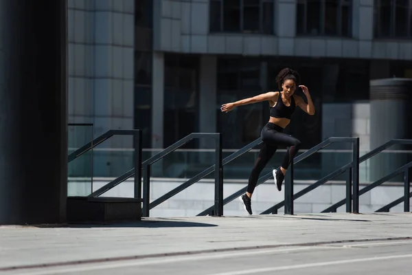 African american runner training near railing on urban street — Stock Photo