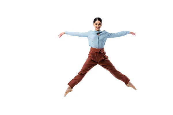 Ballerina smiling at camera while jumping isolated on white — Stock Photo