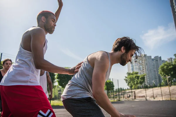 African american sportsman standing near friend on playground outdoors — Stock Photo