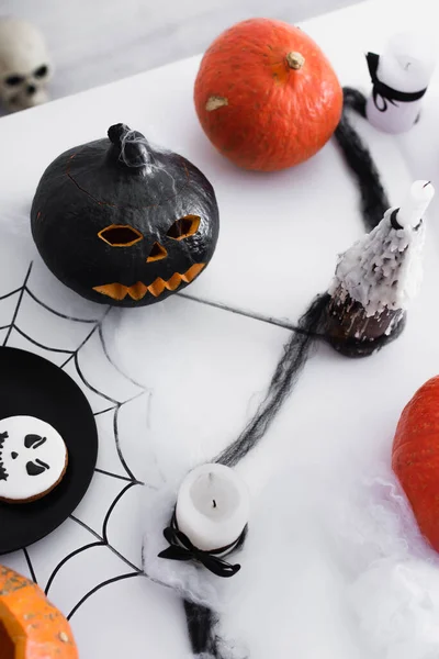 Top view of pumpkins and baked cookie and candles on halloween party — Stock Photo