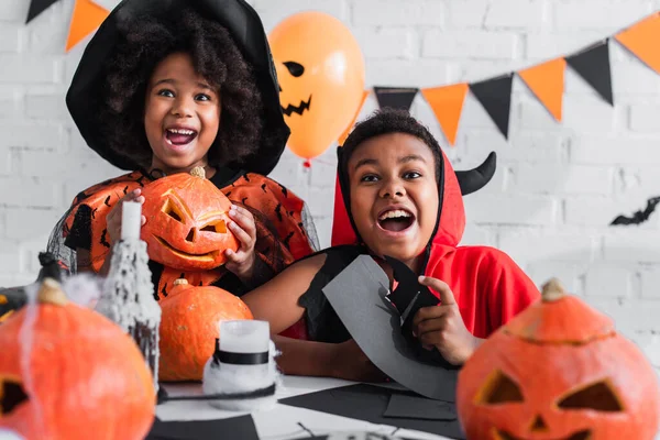 Happy african american kids in halloween costume during party — Stock Photo