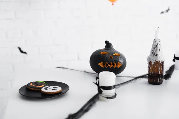 Baked halloween cookies near carved pumpkin and candles — Stock Photo