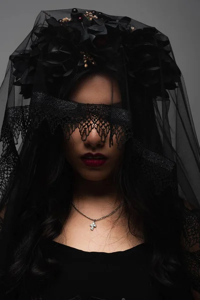Creepy asian woman in vampire halloween costume and black veil isolated on grey — Stock Photo