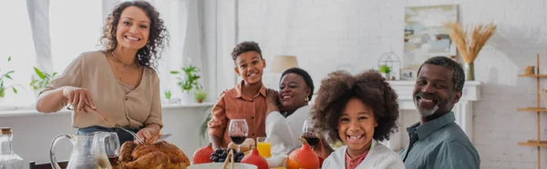 Smiling african american family near thanksgiving dinner at home, banner — Stock Photo
